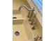 Close-up of a double-basin kitchen sink with brushed-nickel fixtures and a built-in soap dispenser on a neutral countertop at 109 Windcroft Nw Cir, Acworth, GA 30101