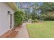 Spacious backyard featuring a stone patio, outdoor seating, and lush greenery at 1152 Ward Creek Sw Dr, Marietta, GA 30064