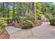 Stone patio overlooking a meticulously landscaped backyard, complete with a charming stone fireplace at 1152 Ward Creek Sw Dr, Marietta, GA 30064