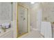 Bright bathroom featuring a tiled walk-in shower with glass doors, tiled floors, and floral wallpaper at 1152 Ward Creek Sw Dr, Marietta, GA 30064