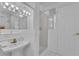 All-white bathroom features pedestal sink, framed mirror, and glass shower at 1152 Ward Creek Sw Dr, Marietta, GA 30064