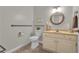 Clean bathroom features a round mirror and grab bars for added safety and convenience at 1152 Ward Creek Sw Dr, Marietta, GA 30064