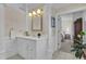 Bright bathroom featuring a white vanity with a sink and mirror, next to an open doorway at 1152 Ward Creek Sw Dr, Marietta, GA 30064