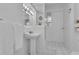 Bright white bathroom featuring a pedestal sink, mirror, and shower at 1152 Ward Creek Sw Dr, Marietta, GA 30064