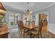 Elegant dining room featuring hardwood floors, bright windows, and access to the kitchen at 1152 Ward Creek Sw Dr, Marietta, GA 30064