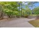 Long driveway leading to a gate and home entrance, with mature trees and manicured landscaping at 1152 Ward Creek Sw Dr, Marietta, GA 30064