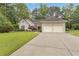 Charming home with a manicured lawn, mature trees, and a two-car garage at 1152 Ward Creek Sw Dr, Marietta, GA 30064