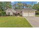 Charming home featuring a well-manicured lawn and a two-car garage, enhancing its curb appeal at 1152 Ward Creek Sw Dr, Marietta, GA 30064