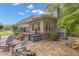 Back of house featuring a stone patio with outdoor seating, grill, and access to yard, perfect for outdoor living at 1152 Ward Creek Sw Dr, Marietta, GA 30064