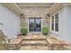Elegant stone entryway with double doors and manicured landscaping, creating a welcoming entrance at 1152 Ward Creek Sw Dr, Marietta, GA 30064