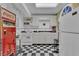 Charming retro-style kitchen with black and white checkered floors and vintage Coca-Cola soda machine at 1152 Ward Creek Sw Dr, Marietta, GA 30064