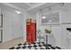 Bright, retro-style kitchen with a Coca-Cola soda machine, checkered floor, and ample counter space at 1152 Ward Creek Sw Dr, Marietta, GA 30064