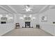 Bright living room featuring a decorative fireplace, elegant wall sconces and classic wainscoting at 1152 Ward Creek Sw Dr, Marietta, GA 30064