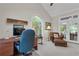 Comfortable office featuring vaulted ceilings, a chair with ottoman, and arched windows providing natural light at 1152 Ward Creek Sw Dr, Marietta, GA 30064