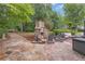 Spacious stone patio with an outdoor fireplace, perfect for entertaining in a tranquil and private backyard oasis at 1152 Ward Creek Sw Dr, Marietta, GA 30064