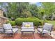 Relaxing patio setting with cozy seating, great for enjoying the beautifully landscaped backyard and a serene outdoor experience at 1152 Ward Creek Sw Dr, Marietta, GA 30064