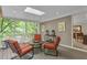 Covered screened-in patio featuring outdoor seating and views of lush greenery at 1152 Ward Creek Sw Dr, Marietta, GA 30064