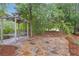 Charming outdoor swing set on a stone patio surrounded by lush greenery, creating a relaxing and picturesque backyard retreat at 1152 Ward Creek Sw Dr, Marietta, GA 30064