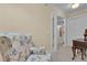 Bright sitting area with a floral chair and view to another room through glass doors at 1152 Ward Creek Sw Dr, Marietta, GA 30064