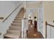 Traditional staircase with carpeted steps, wooden banister, and view of the home's interior at 1152 Ward Creek Sw Dr, Marietta, GA 30064