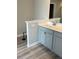 Bathroom features double vanity with white countertop and gray cabinets at 11600 Winston Dr, Hampton, GA 30228
