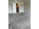 Spacious bedroom with neutral carpet, light walls and door at 11600 Winston Dr, Hampton, GA 30228