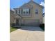 Charming two-story home with a two-car garage and a well-maintained front yard at 11600 Winston Dr, Hampton, GA 30228