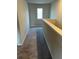 Upstairs hallway with carpet and window at 11600 Winston Dr, Hampton, GA 30228