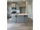 Bright kitchen features a center island, gray cabinets, and stainless steel appliances at 11600 Winston Dr, Hampton, GA 30228
