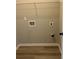 Efficient laundry room with hookups and wood-look flooring at 11600 Winston Dr, Hampton, GA 30228