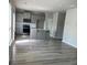 Spacious living area with modern wood floors and an island at 11600 Winston Dr, Hampton, GA 30228