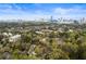 Scenic aerial view of the city skyline from the home's location, with lush greenery in the foreground at 4 Vale Close Ne Ct, Atlanta, GA 30324
