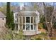 Back exterior view of a two-story home with lush landscaping and a stone patio at 4 Vale Close Ne Ct, Atlanta, GA 30324