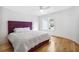 Cozy bedroom with hardwood floors, a large window, and a soft purple headboard at 4 Vale Close Ne Ct, Atlanta, GA 30324