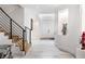 Elegant foyer with wooden staircase, marble floors, and modern art accents at 4 Vale Close Ne Ct, Atlanta, GA 30324