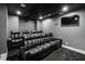 Home theater with comfortable leather seating, projector, screen, and dark gray color scheme at 4 Vale Close Ne Ct, Atlanta, GA 30324