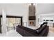 Bright living area featuring a stone fireplace, large windows, and stylish decor at 4 Vale Close Ne Ct, Atlanta, GA 30324