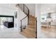 Elegant curved staircase with modern iron railing, connecting living spaces at 4 Vale Close Ne Ct, Atlanta, GA 30324