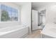 Bathroom with large tub and bright window at 48 Savanna Ct, Powder Springs, GA 30127