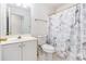 Cozy bathroom featuring a vanity, toilet, and a shower with a decorative curtain at 48 Savanna Ct, Powder Springs, GA 30127