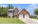 Charming two-story brick home with manicured lawn and attached two-car garage at 48 Savanna Ct, Powder Springs, GA 30127
