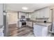 Modern kitchen with stainless steel appliances, granite countertops, and hardwood floors at 48 Savanna Ct, Powder Springs, GA 30127