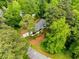 A bird's eye view of a house nestled amongst lush, mature trees in a well-maintained neighborhood at 504 Kingswood Nw Ln, Atlanta, GA 30305