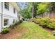 Large grassy backyard with a patio area and mature trees and lush landscaping at 504 Kingswood Nw Ln, Atlanta, GA 30305