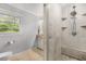 Contemporary bathroom with tiled floors, glass shower with built-in shelves and modern fixtures at 504 Kingswood Nw Ln, Atlanta, GA 30305