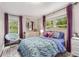 Charming bedroom with large windows, a comfortable bed, decorative mirror and a cozy round papasan chair at 504 Kingswood Nw Ln, Atlanta, GA 30305