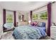 Bright bedroom with a whimsical decor, cozy throw chair, and beautiful natural light at 504 Kingswood Nw Ln, Atlanta, GA 30305