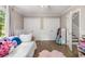 Bedroom featuring two double closets, a daybed, wood floors and large window at 504 Kingswood Nw Ln, Atlanta, GA 30305