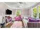 Bedroom featuring two large windows, a ceiling fan, a flat screen TV and a daybed at 504 Kingswood Nw Ln, Atlanta, GA 30305