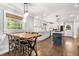 Cozy dining room features a rustic wooden table, stylish seating, and a window with natural light at 504 Kingswood Nw Ln, Atlanta, GA 30305